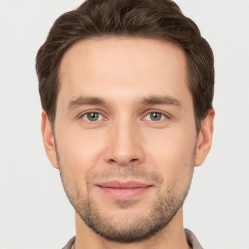 Joyful white young-adult male with short  brown hair and brown eyes