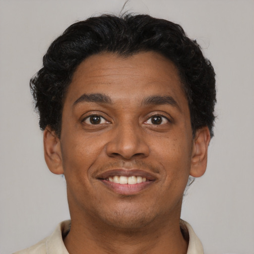 Joyful latino young-adult male with short  brown hair and brown eyes