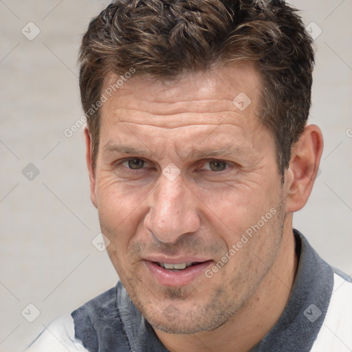 Joyful white middle-aged male with short  brown hair and brown eyes