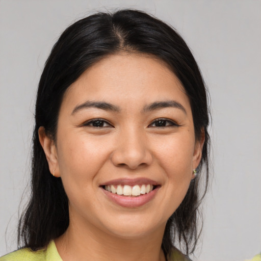 Joyful asian young-adult female with medium  brown hair and brown eyes