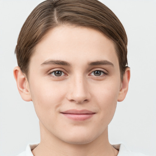 Joyful white young-adult female with short  brown hair and grey eyes