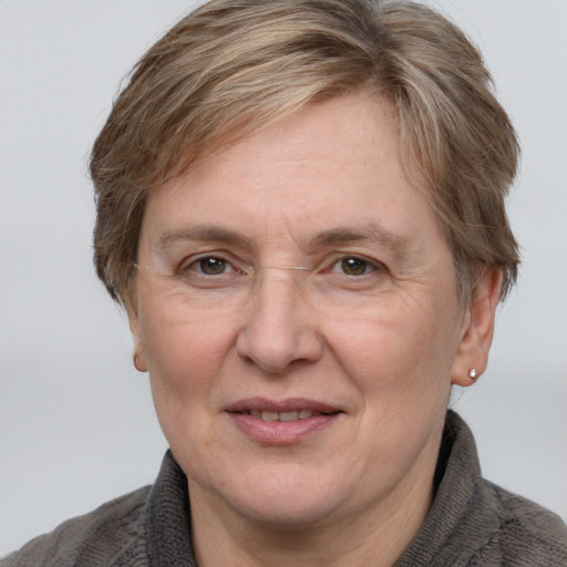 Joyful white adult female with short  brown hair and grey eyes