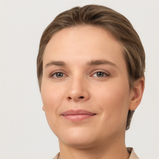 Joyful white young-adult female with short  brown hair and grey eyes