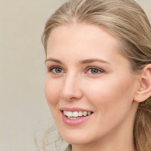 Joyful white young-adult female with long  brown hair and grey eyes