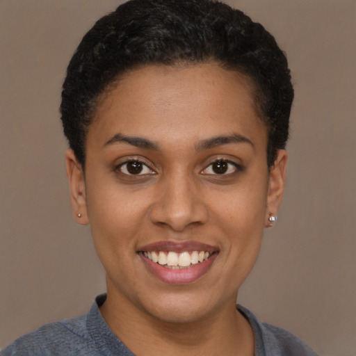 Joyful latino young-adult female with short  brown hair and brown eyes