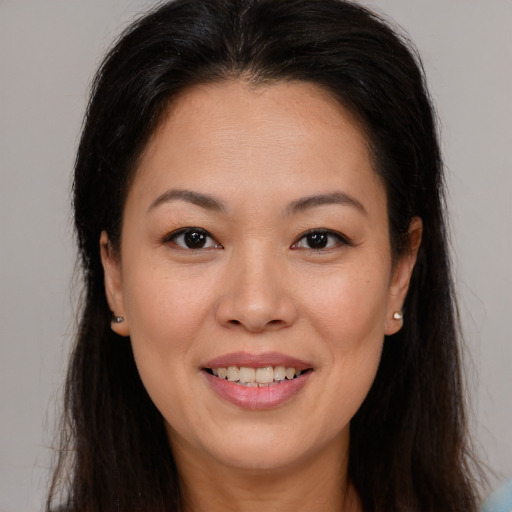 Joyful asian young-adult female with long  brown hair and brown eyes
