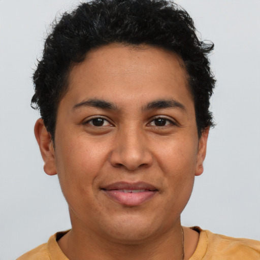 Joyful latino young-adult female with short  brown hair and brown eyes