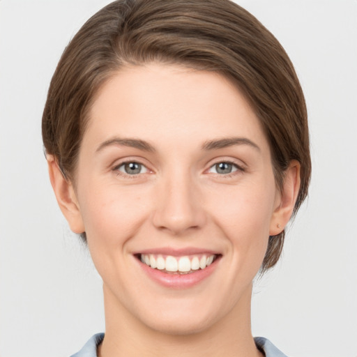 Joyful white young-adult female with short  brown hair and grey eyes