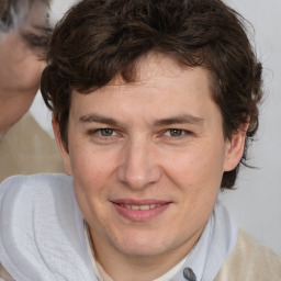 Joyful white young-adult male with medium  brown hair and brown eyes