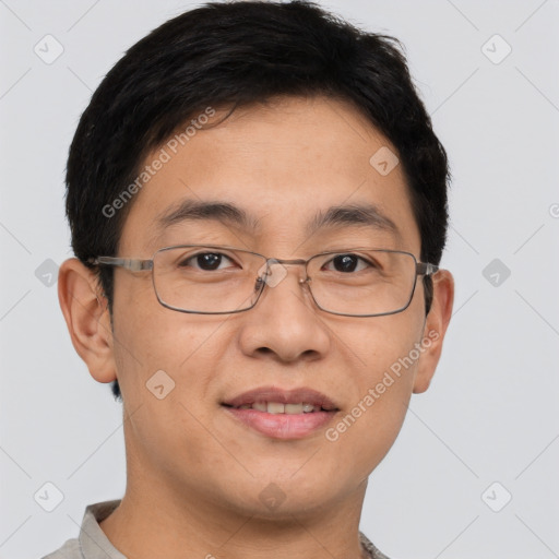 Joyful asian young-adult male with short  brown hair and brown eyes