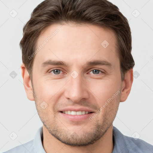 Joyful white young-adult male with short  brown hair and grey eyes