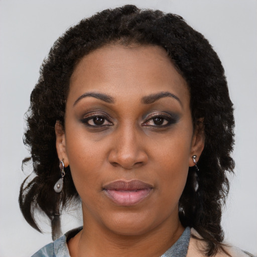 Joyful black young-adult female with medium  brown hair and brown eyes