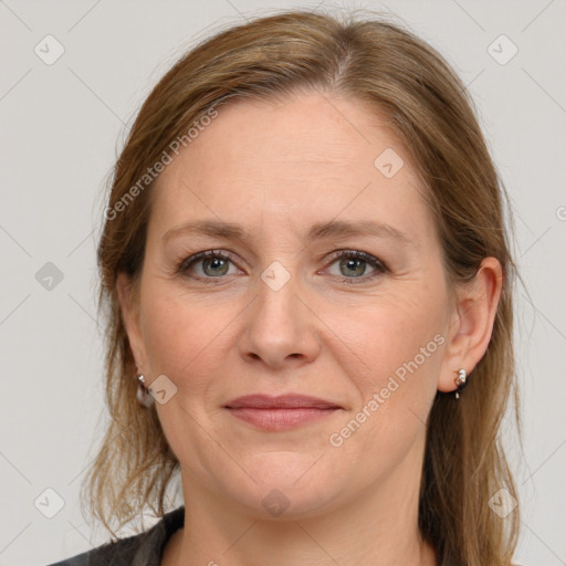 Joyful white adult female with long  brown hair and grey eyes