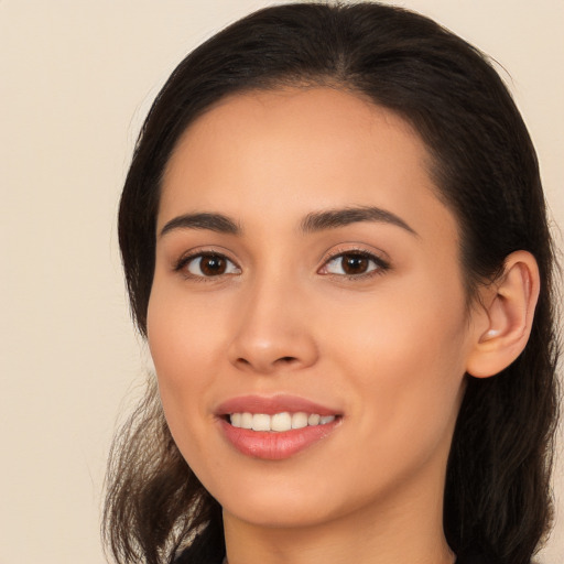 Joyful latino young-adult female with long  brown hair and brown eyes