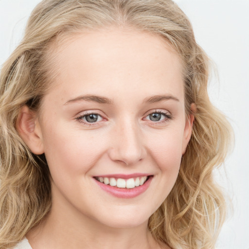 Joyful white young-adult female with long  brown hair and blue eyes