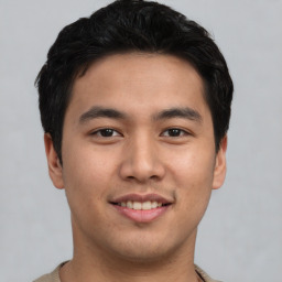 Joyful asian young-adult male with short  black hair and brown eyes