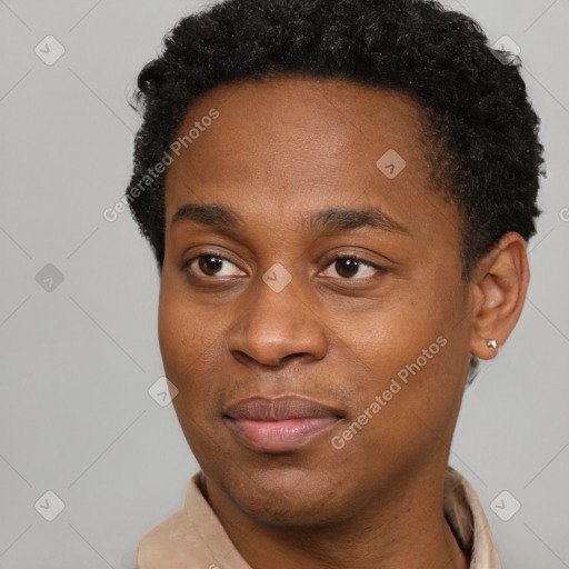 Joyful black young-adult male with short  brown hair and brown eyes