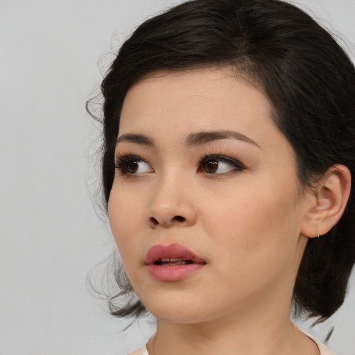 Neutral asian young-adult female with medium  brown hair and brown eyes