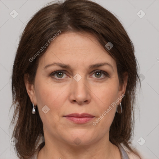 Joyful white adult female with medium  brown hair and grey eyes