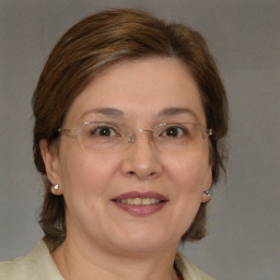 Joyful white adult female with medium  brown hair and brown eyes