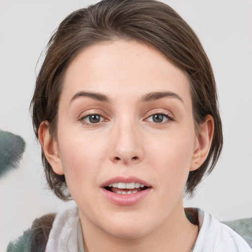 Joyful white young-adult female with medium  brown hair and blue eyes