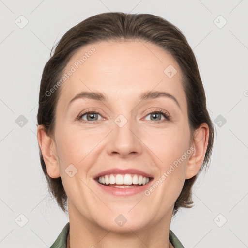 Joyful white adult female with medium  brown hair and grey eyes