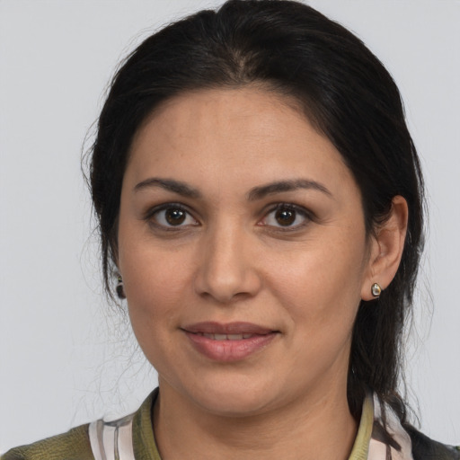 Joyful latino young-adult female with medium  brown hair and brown eyes