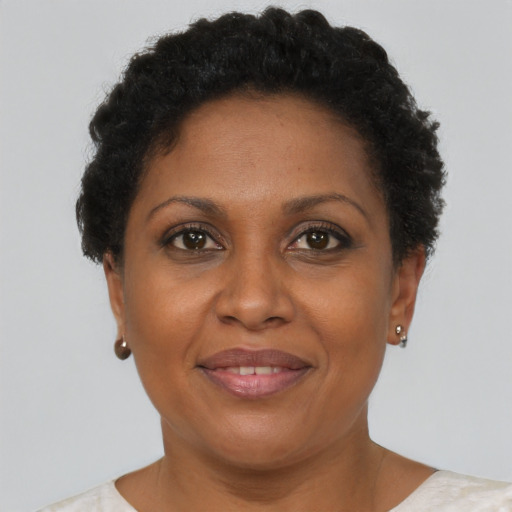 Joyful black adult female with short  brown hair and brown eyes
