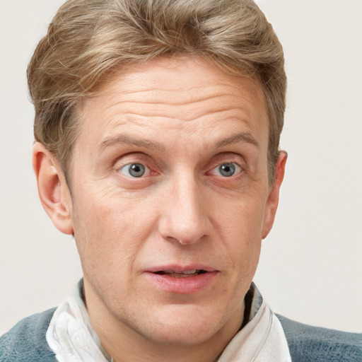 Joyful white adult male with short  brown hair and blue eyes