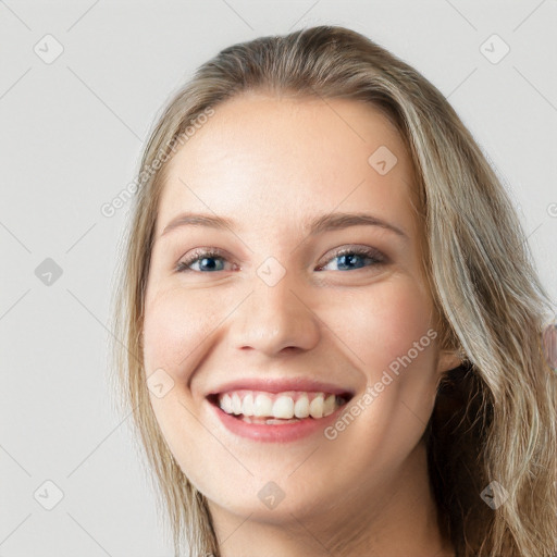 Joyful white young-adult female with long  brown hair and blue eyes