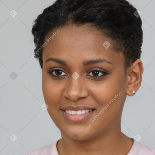 Joyful black young-adult female with short  brown hair and brown eyes