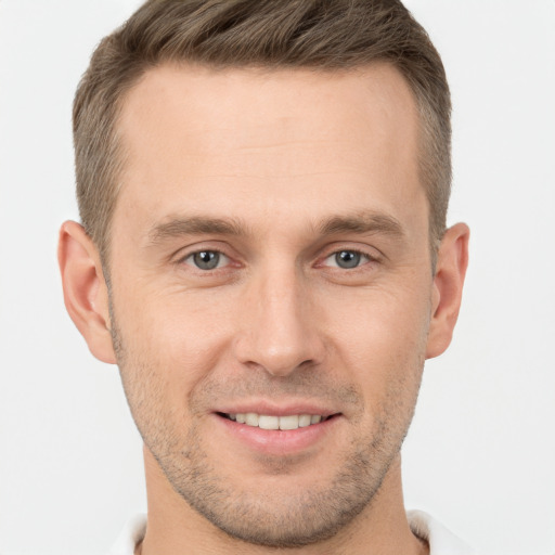 Joyful white young-adult male with short  brown hair and brown eyes