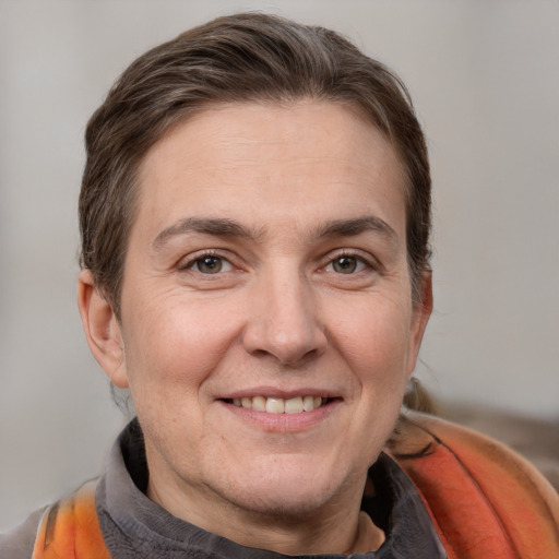 Joyful white adult female with medium  brown hair and grey eyes