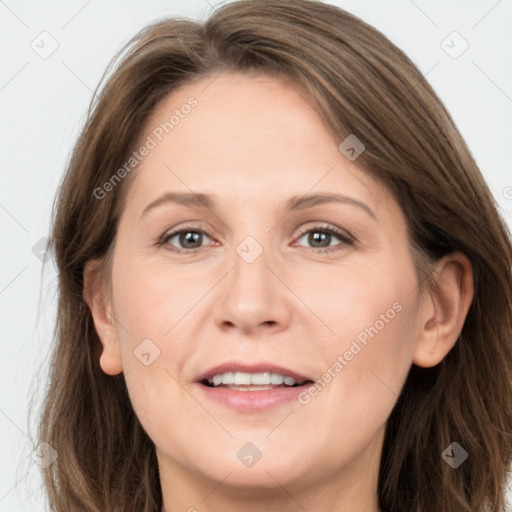 Joyful white adult female with long  brown hair and grey eyes