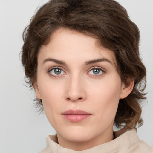 Joyful white young-adult female with medium  brown hair and green eyes