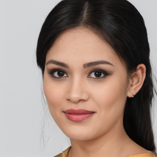 Joyful latino young-adult female with medium  brown hair and brown eyes