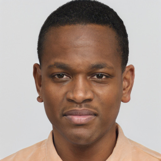 Joyful black young-adult male with short  brown hair and brown eyes