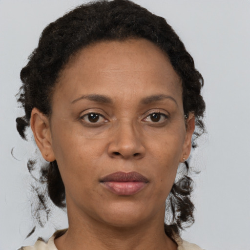 Joyful black adult female with short  brown hair and brown eyes