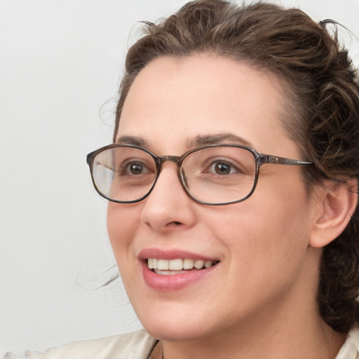 Joyful white adult female with medium  brown hair and blue eyes