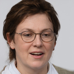 Joyful white adult female with medium  brown hair and blue eyes