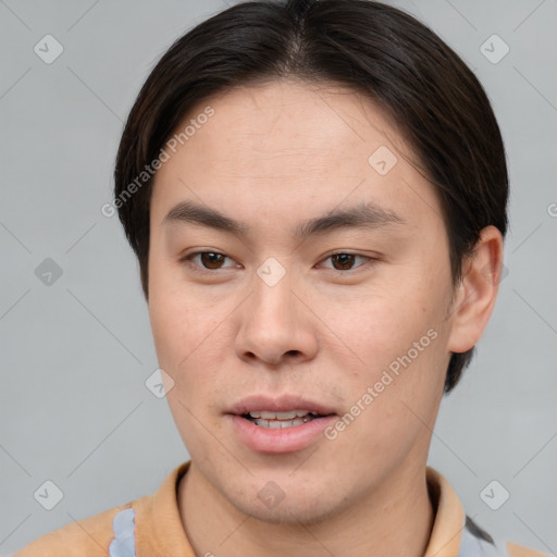 Joyful asian young-adult male with short  brown hair and brown eyes