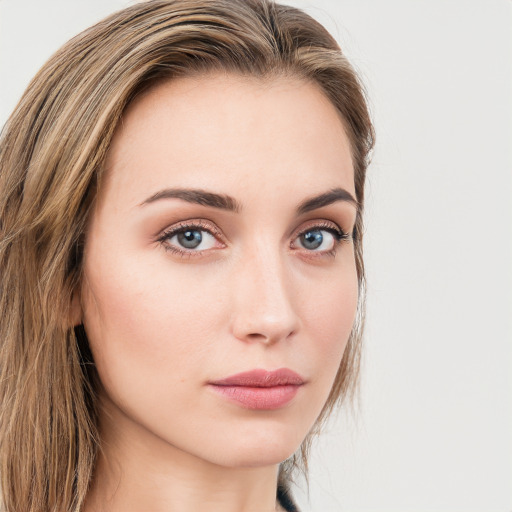 Neutral white young-adult female with long  brown hair and green eyes