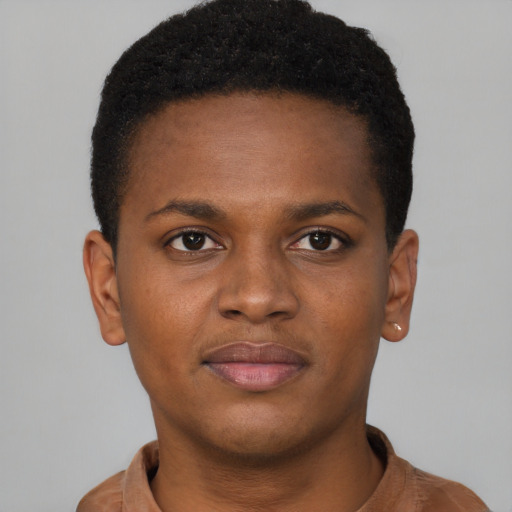 Joyful black young-adult male with short  brown hair and brown eyes
