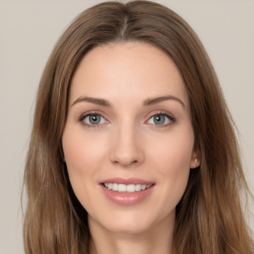 Joyful white young-adult female with long  brown hair and green eyes