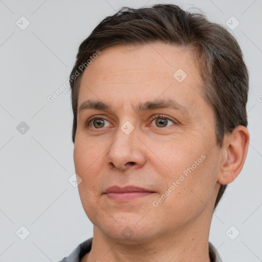 Joyful white adult male with short  brown hair and brown eyes