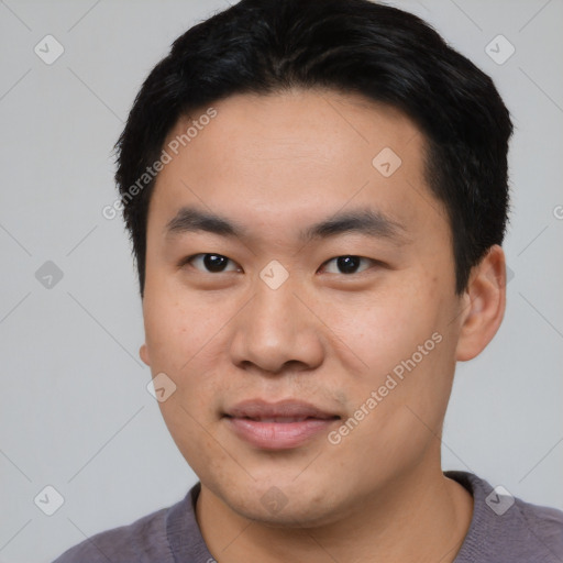 Joyful asian young-adult male with short  black hair and brown eyes