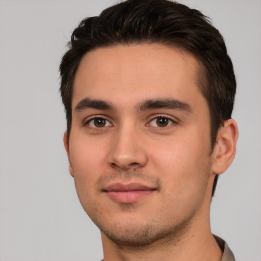 Joyful white young-adult male with short  brown hair and brown eyes