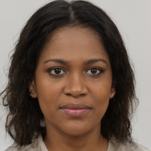 Joyful black young-adult female with medium  brown hair and brown eyes