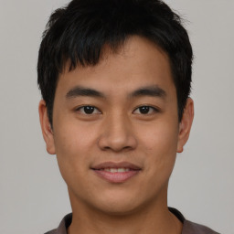 Joyful asian young-adult male with short  black hair and brown eyes