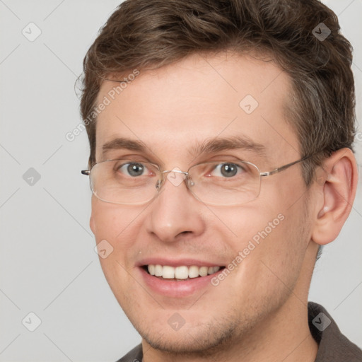 Joyful white adult male with short  brown hair and grey eyes